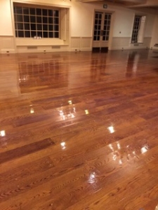 Image of a clean polished wood floor done by our team for a commercial cleaning services in NH